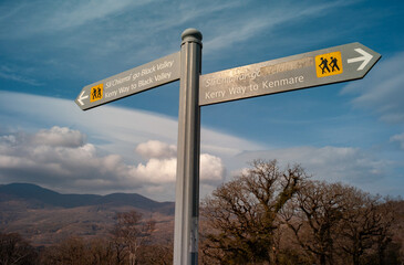 Hiking direction signposts in Killarney national park, Hiking trails towards the Kerry Way, Black...
