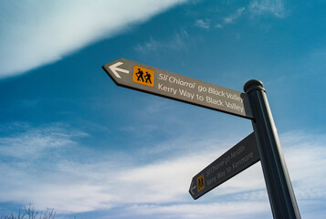 Hiking direction signposts in Killarney national park, Hiking trails towards the Kerry Way, Black...