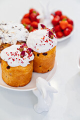 decorated panettones and cruffins on serving plates with rabbits. easter cakes. 