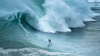 A surfer in the waves of Nazaré in Portugal 