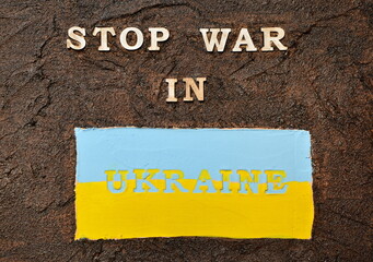 Text on a dark background. Stop the war in Ukraine. blue and yellow background. Plaster. Textured plaster. postcard. background. Ukraine. Conflict. War.