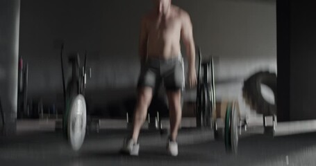 Muscular sportsman doing snatch exercise with barbell