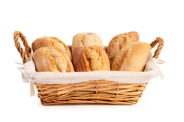 Fresh wheat buns in a wicker basket isolated on a white background