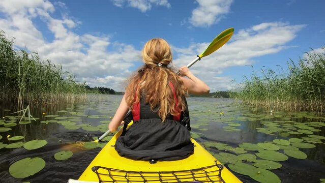 Active young woman paddling on an kayak on in Finland. Family Sports. Summer. Travel. Tourism