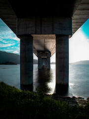 A long exposure of a bridge that goes into the sea