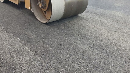 Repair new road asphalting roller. Applying hot resin sidewalk. Industrial equipment with smooth...