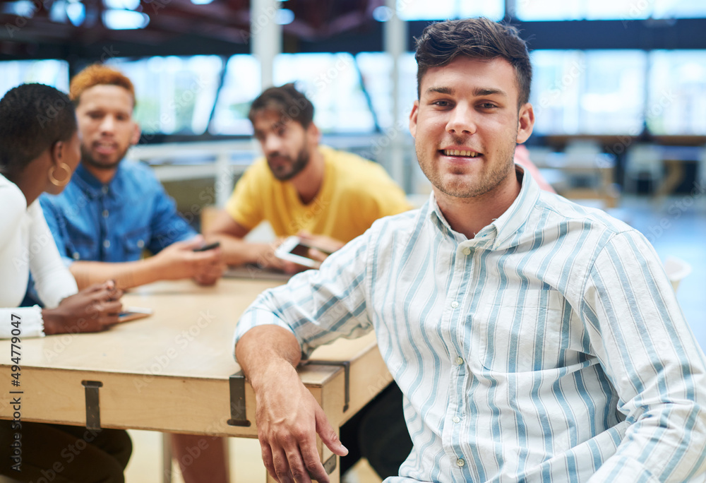Poster im in charge of this team task. shot of a young businessman having a meeting with his team in a mode