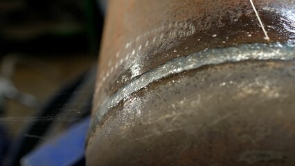 Manufacture of pipes for water. Heavy metal industry. Checking the weld seam with water.