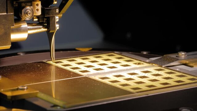 Automatic desktop wire bonder and tester machine during work at exhibition or trade show - close up. Robotic, electronic, production, industrial and wire bond testing concept