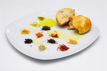 types of salt, plate with different types of salt with olive oil and bread on a plate to taste on a white background