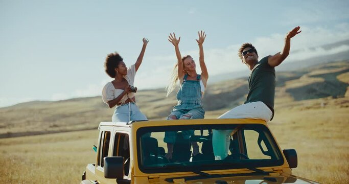 Three best friends dancing and laughing on the roof of their car on summer road trip, travel and adventure lifestyle