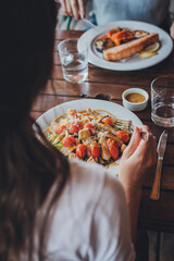 two women eating fresh salads in a restaurant