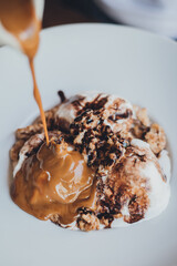 drizzle of candy covering a brownie with ice cream dessert