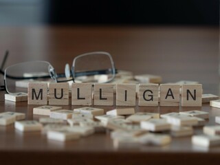 mulligan word or concept represented by wooden letter tiles on a wooden table with glasses and a...