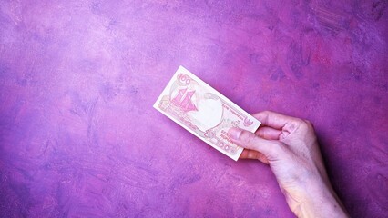 Indonesian Rupiah the official currency of Indonesia. Man's hand is making a payment. Business...