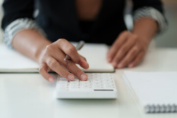 Business woman hand holding pen looking at bank savings account application on cell phone. account or saving money or insurance concept.