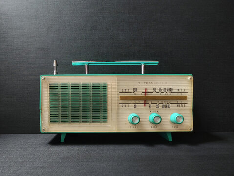 old transistor radio on black wallpaper background