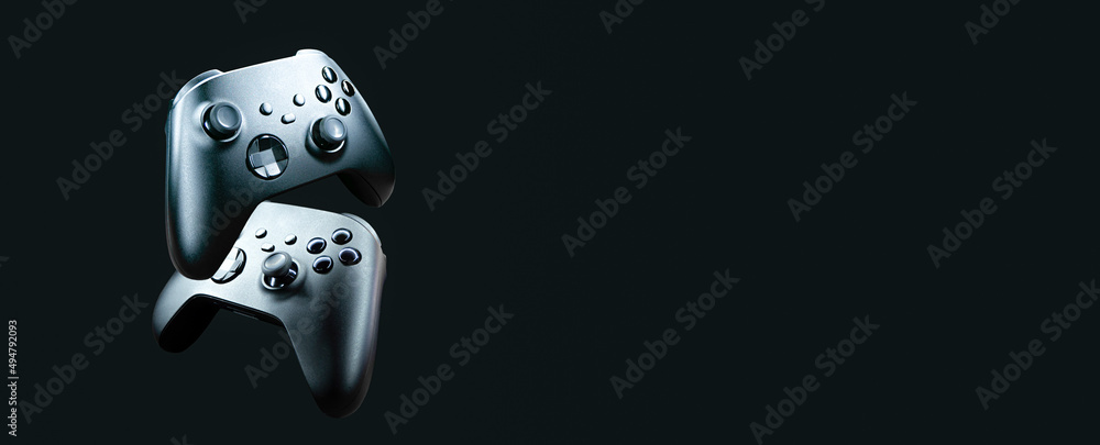 Aufkleber 2 game controllers floating on black background - future of gaming concept