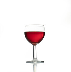 red wine in a transparent glass with reflection isolated over white background