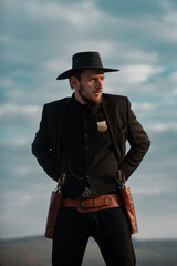 Sheriff in cowboy hat. Man with wild west guns, vintage pistol revolver and marshal ammunition. US...