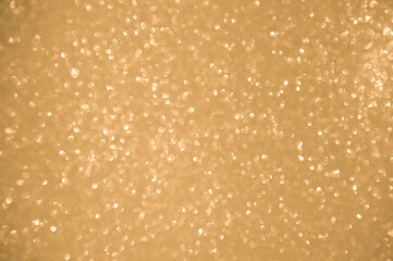 Gold glitters background. shimmering blur spot lights Bokeh Shiny gold light background.