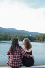 Fototapeta premium Beautiful women LGBT Lesbian Couple intimate moments. Young couple multiracial female friends. multi-ethnic female couple in love hug each other