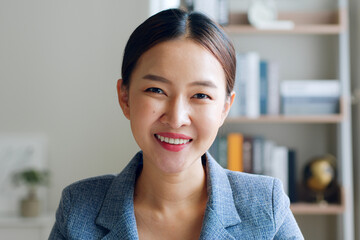 Portrait of young Asian businesswoman working in formal suit look at camera and smile