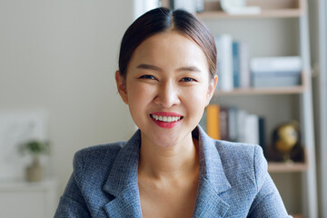 Portrait of young Asian businesswoman working in formal suit look at camera and smile - obrazy, fototapety, plakaty