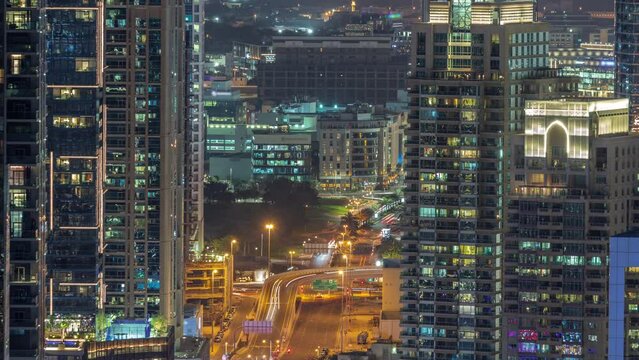 Dubai Marina and Media City districts with modern skyscrapers and office buildings aerial night timelapse.