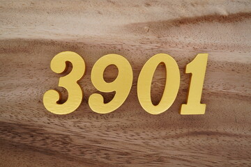 Golden Arabic numerals on a real brown and white wooden floor number 3901