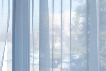 Sheer white tulle curtains on the windows.