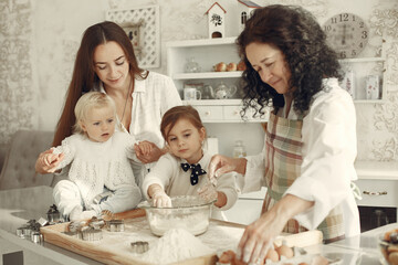 Obraz na płótnie Canvas Family cook the dough for cookies