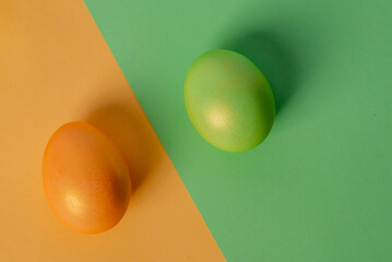  green egg on a green background and a yellow one on a yellow.High quality photo