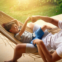 Daddys always got your back my boy. Cropped shot of a father and his adorable son chilling on the...