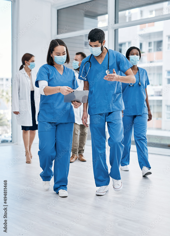 Poster they communicate often and share resources where needed. shot of two medical practitioners going thr