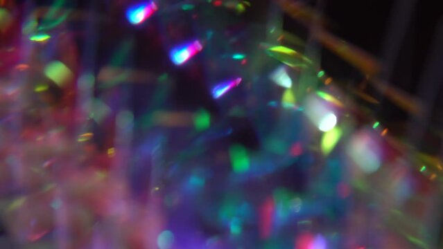 Crystal prism refracting light in vivid rainbow colors. Diamond neon purple holographic background