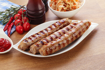 Grilled sausages with cabbage and sauce