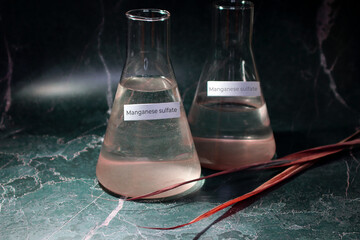 Manganese sulfate in water, in a flask. MnSO4