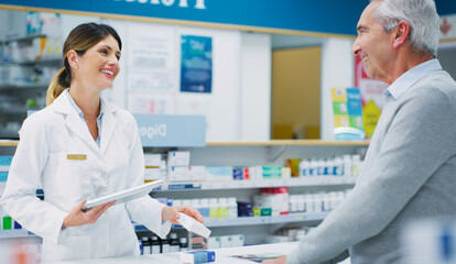 Hes leaving with a filled prescription and a big smile. Shot of a pharmacist assisting a customer in a chemist.