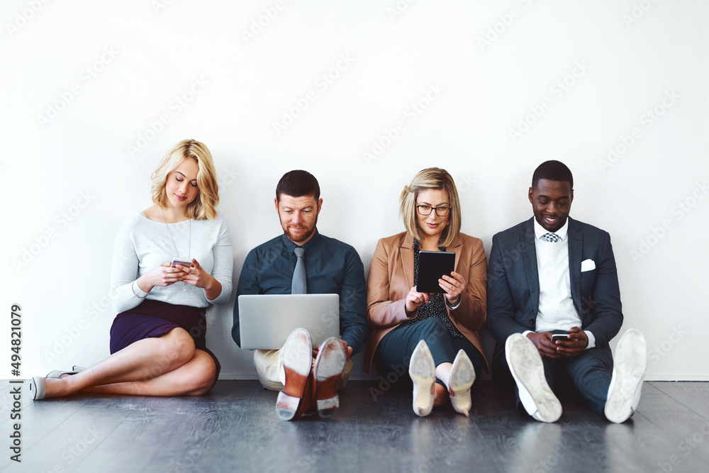 Poster wireless networking has many advantages to offer. shot of a group of entrepreneurs using wireless de