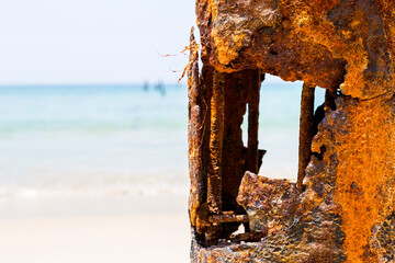 Closeup rusty pole over blurred beach background, ruin old steel pole, outdoor day light