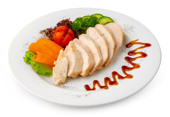 Pieces of boiled chicken breast with vegetables over white background