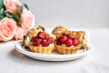 Delicious tartlets dessert assorted pastries. Mini tartlets with cream  filling and strawberry. Closeup of delicious pastry sweets pies.