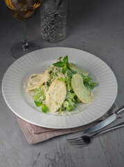 georgian green salad with nadugi on gray background