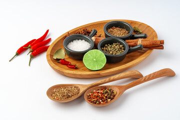 Set of spices in bowls with chili peppers on white background