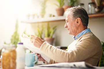 This crossword looks like a challenge. Cropped shot of a senior man reading a newspaper with his breakfast outdoors.