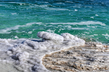 Crystal salt on a rock near beach in the Dead Sea. Israel