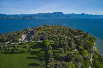 Aerial view of the Grotte di Catullo ruins of a large Roman villa on the peninsula. Olive grove and...