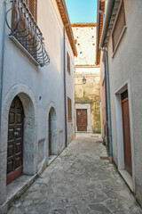 A narrow street among the old stone houses of Taurasi, town in Avellino province, Italy.