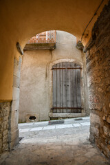 A narrow street among the old stone houses of Taurasi, town in Avellino province, Italy.